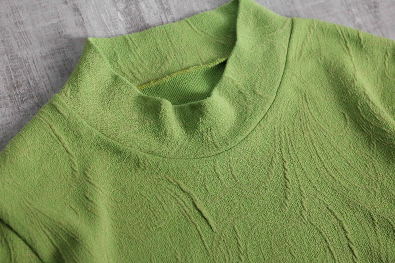 green botanical like wrinkled off neck knit