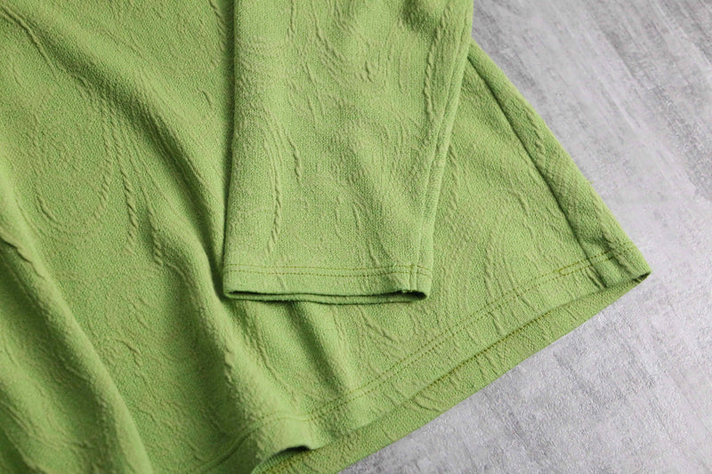 green botanical like wrinkled off neck knit