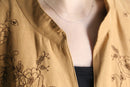 botanical embroidery over coat