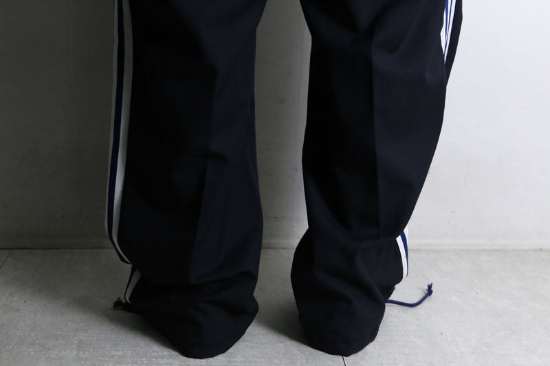 "Re:make" track × slacks layered mesh pants