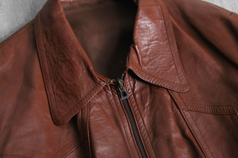 brown wide-collar leather bomber jacket
