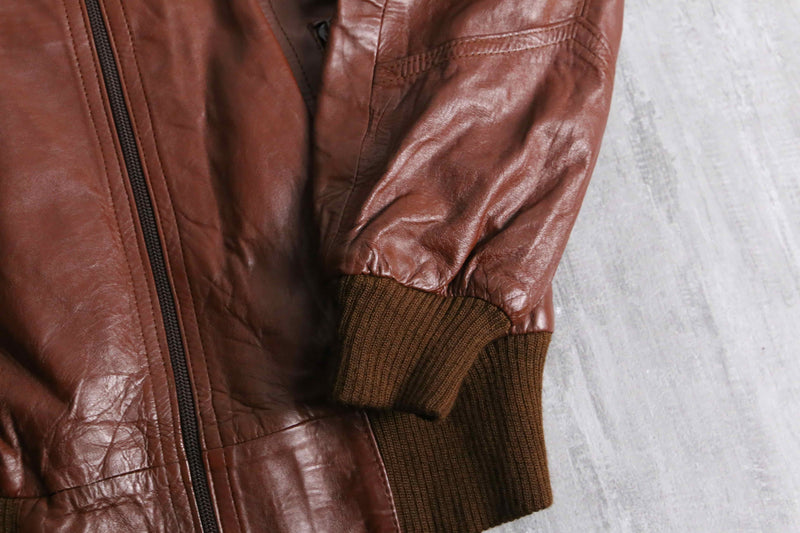 brown wide-collar leather bomber jacket