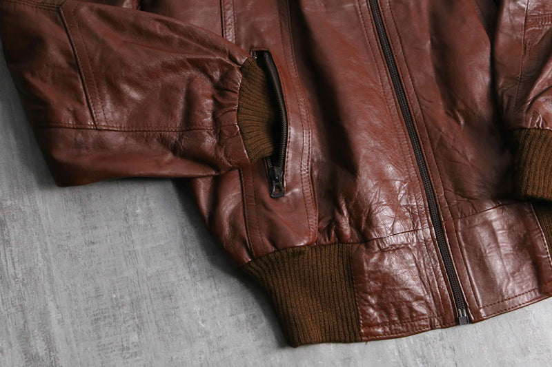 brown wide-collar leather bomber jacket