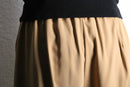 beige wide tuck slacks