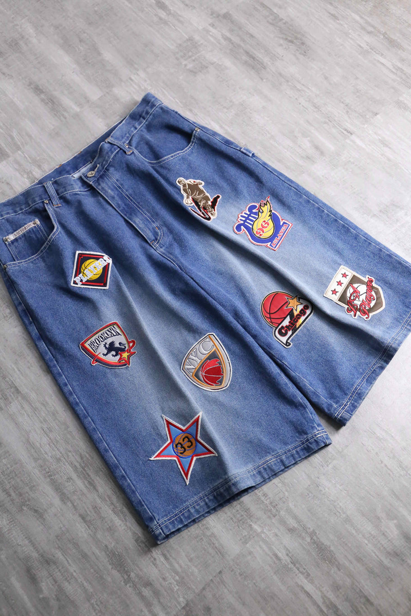 patch design over denim short pants
