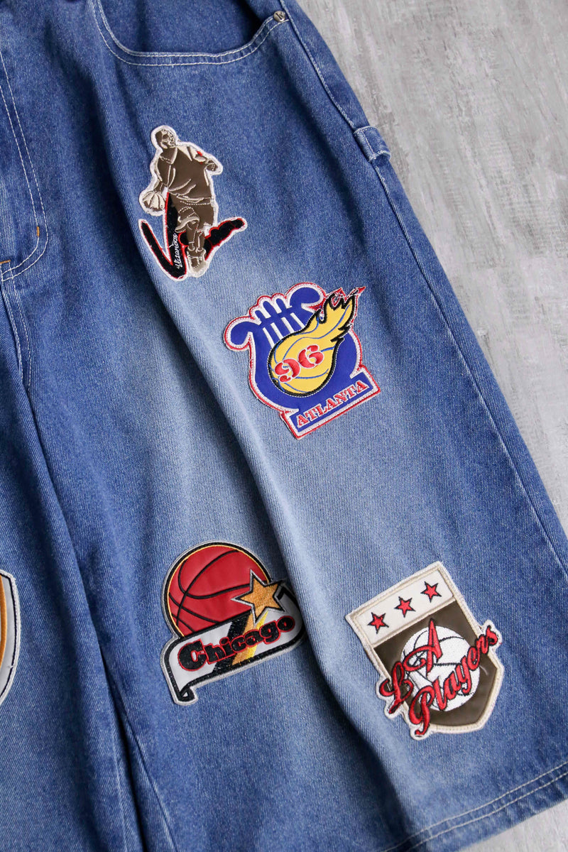 patch design over denim short pants