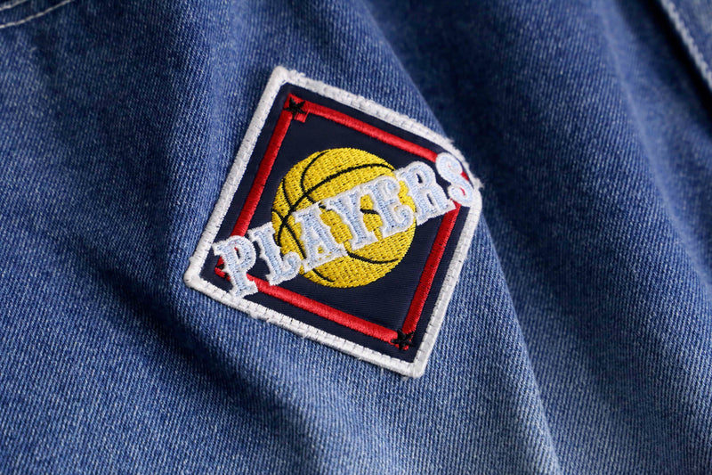 patch design over denim short pants