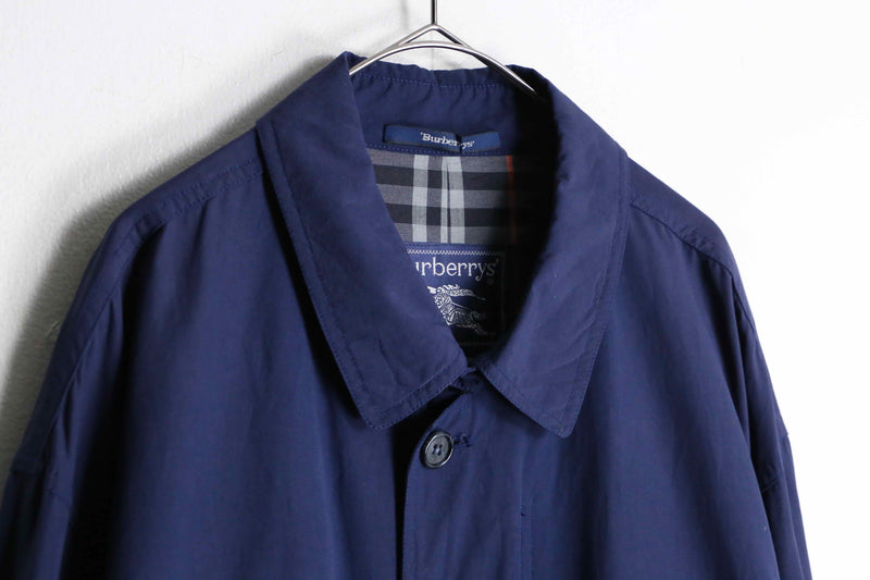 “Burberry’s” navy color front fly half coat